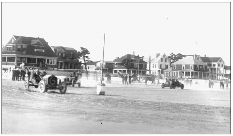 Race cars are seen here turning at the mile-and-a-quarter pole at the foot of - photo 5