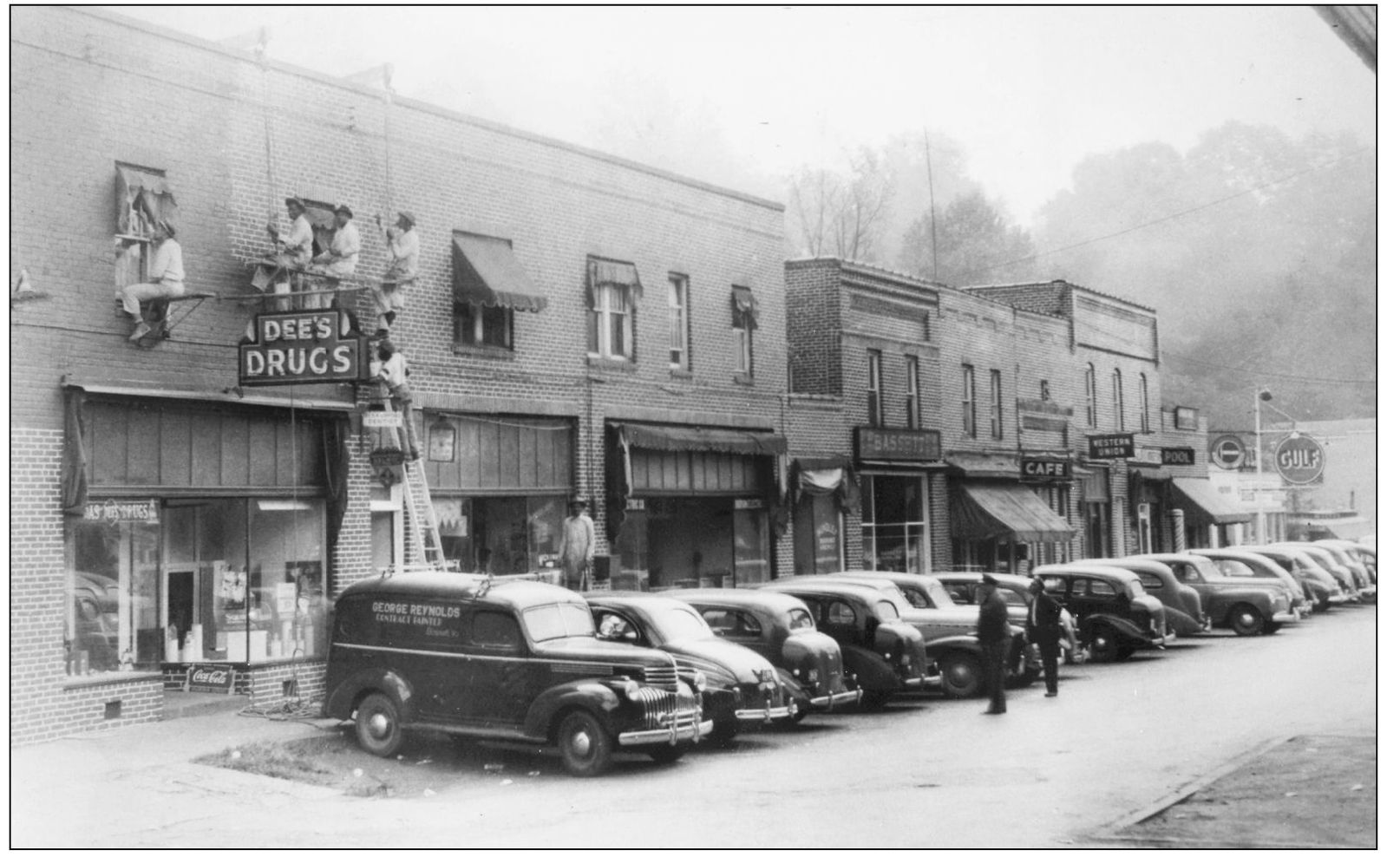 Workers repair the Reed Stone Blocks brick facing and clean windows while a - photo 5