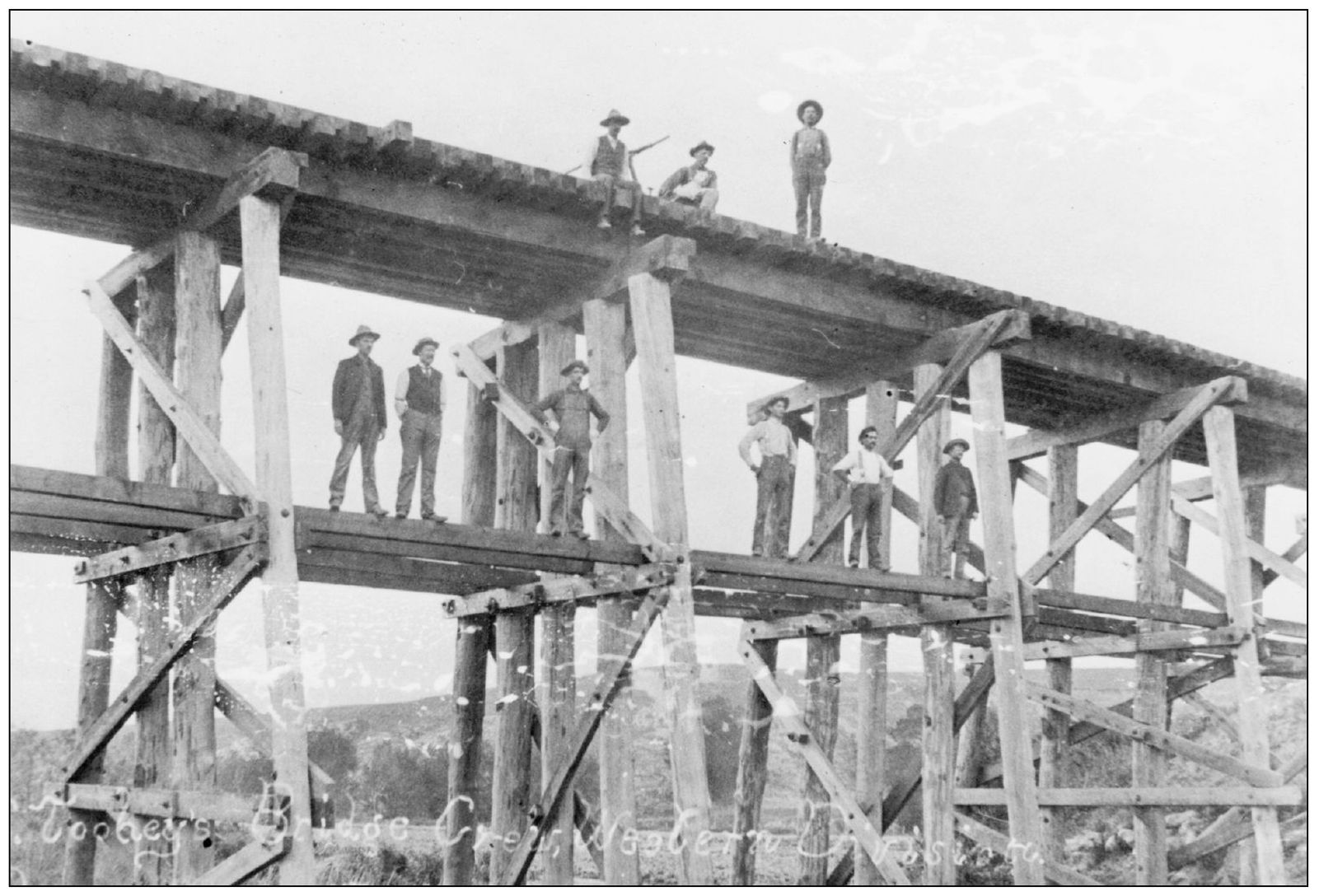 This photograph taken between 1900 and 1904 shows a bridge crew working on a - photo 14