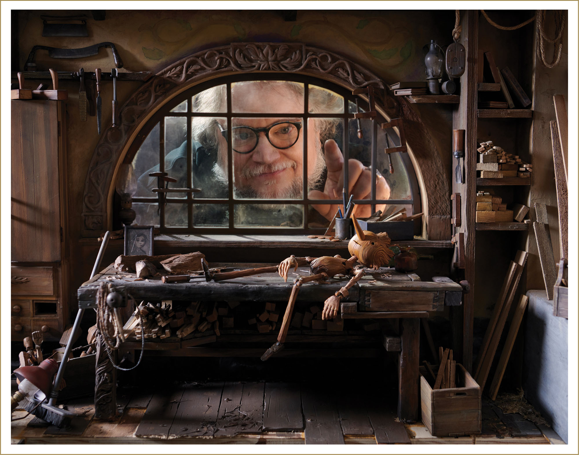 Guillermo del Toro looks through the window of the Geppettos workshop set - photo 7