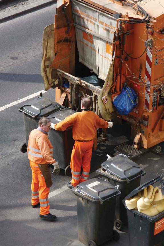 Garbage collectors dump bags and bins full of garbage into trucks every day - photo 3