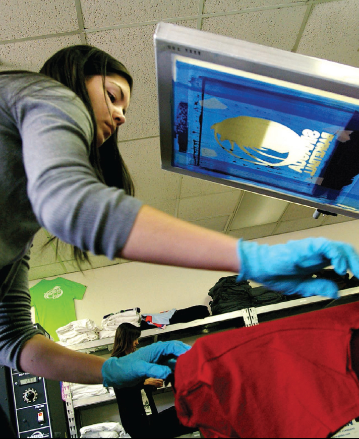 A high school student works in a student-run silkscreen business that prints - photo 2