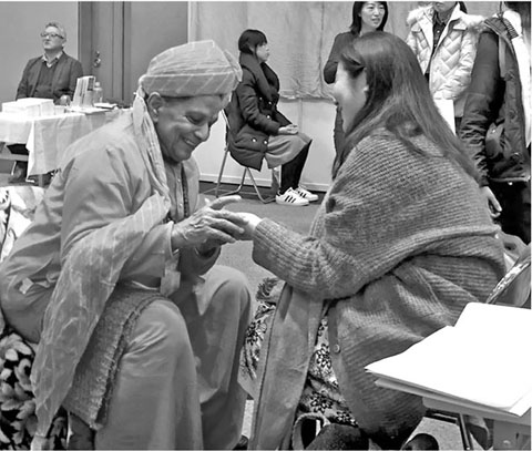 Traditional Indian Astro-palmist examining a clients palm A line originating - photo 6