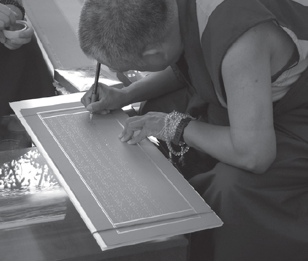 Lama Zopa Rinpoche writing in gold one of hundreds of folios of The - photo 11
