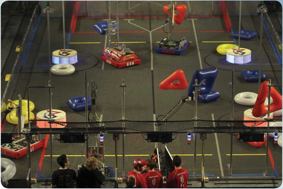 Robots fill the venue floor during the FIRST Robotics Competition held at - photo 5