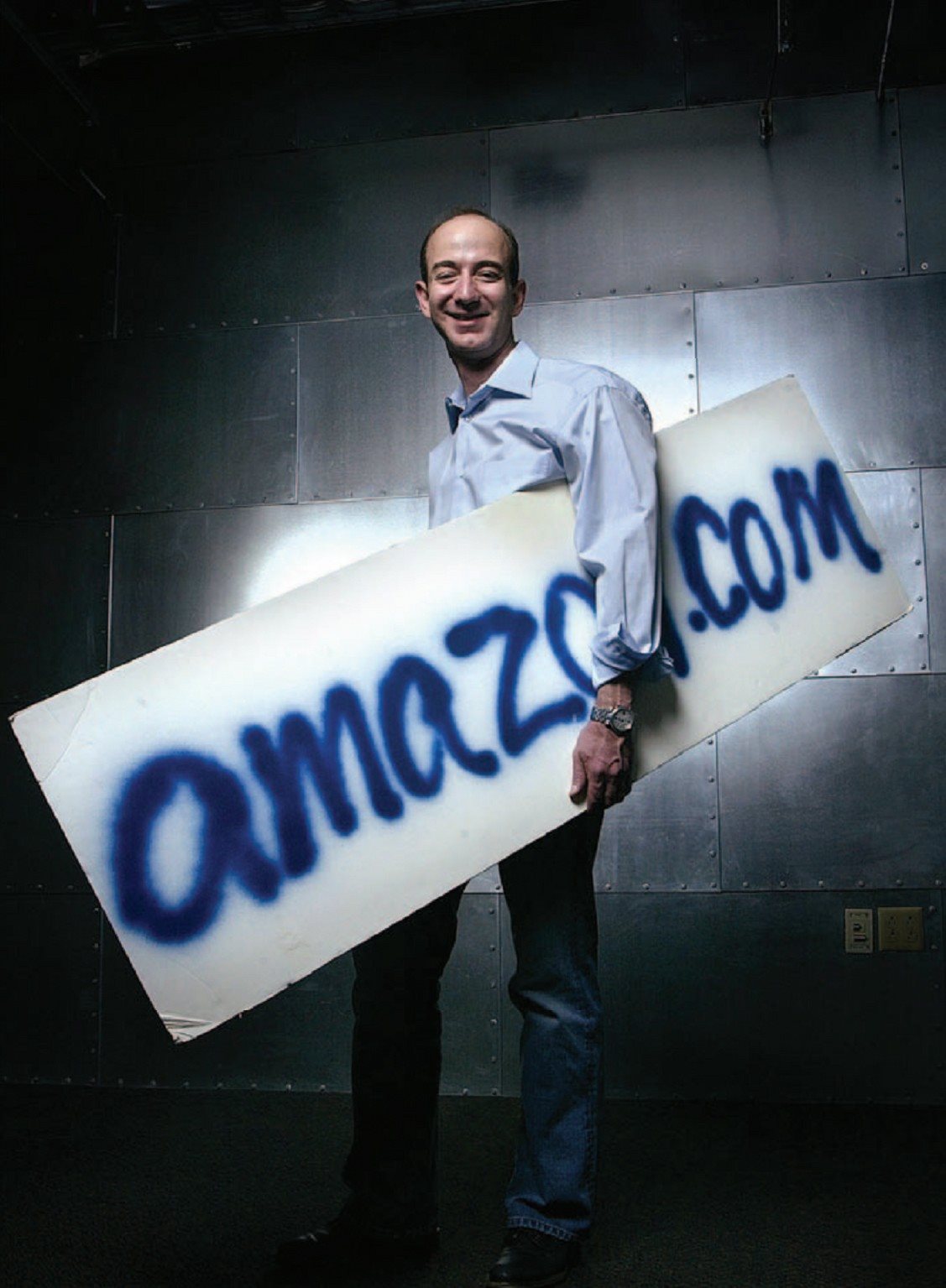 Jeff Bezos holds Amazons first sign while standing in the companys Seattle - photo 2