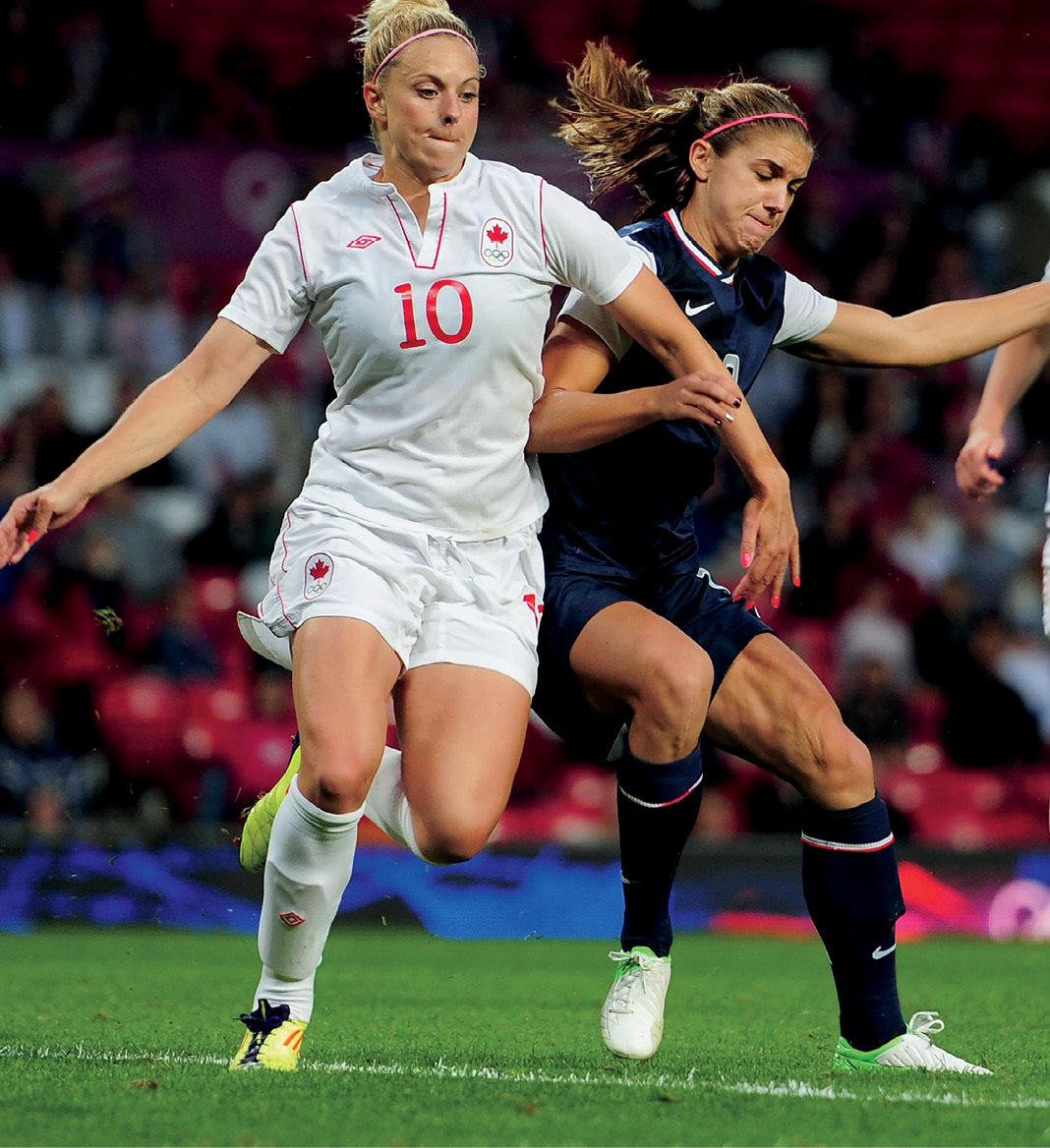 Alex Morgan middle fights Canada for control of the ball in the 2012 - photo 17