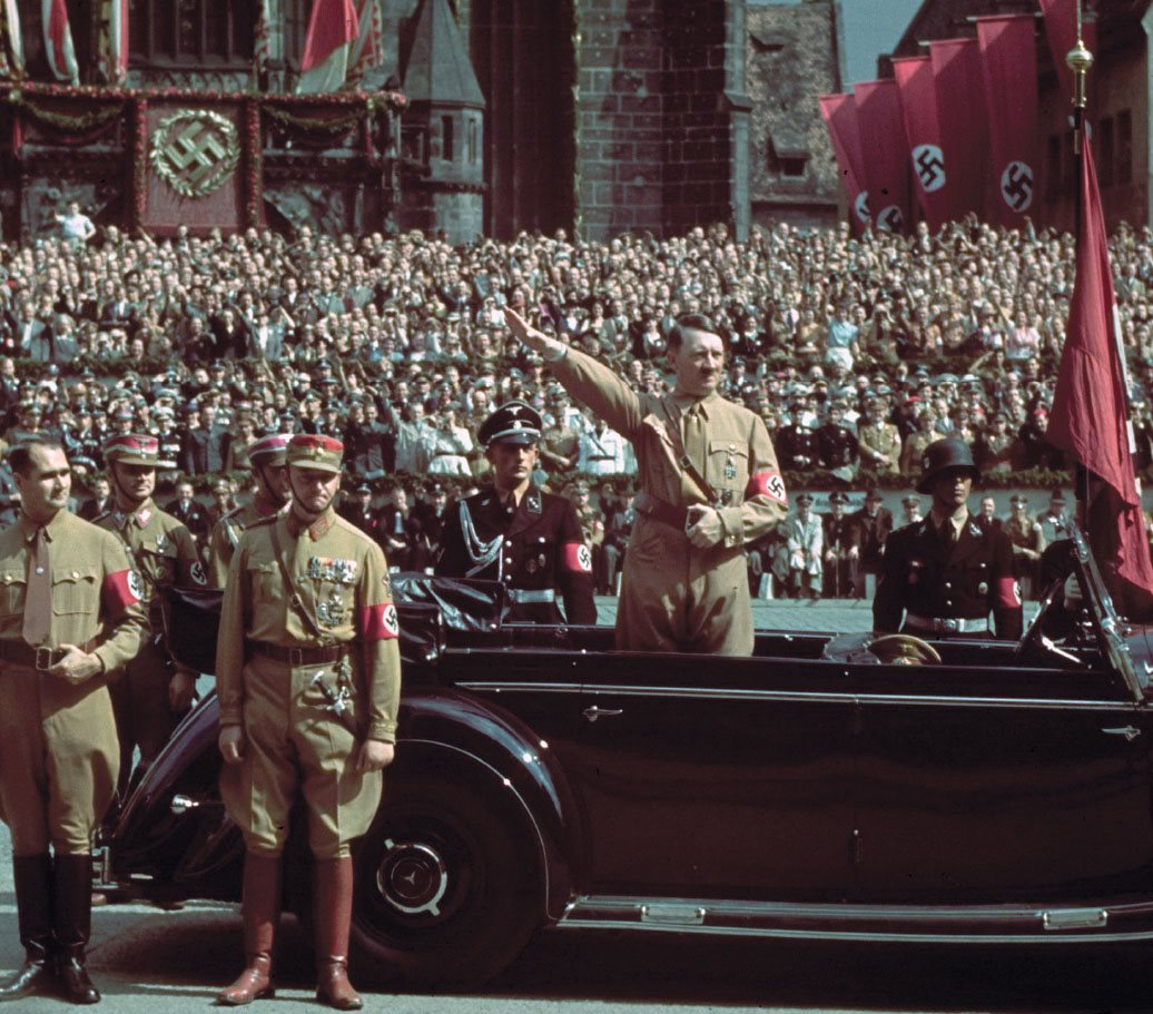 Rudolf Hess stands next to SA commander Viktor Lutze as Hitler takes the salute - photo 3