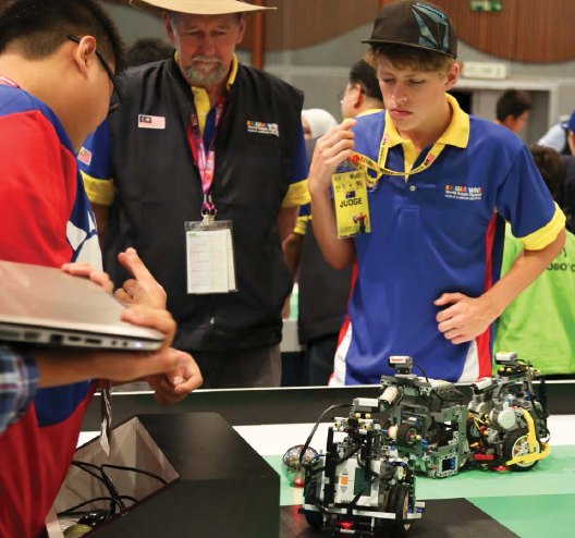 At the 2012 World Robot Olympaid in Malaysia these students watch their robots - photo 6