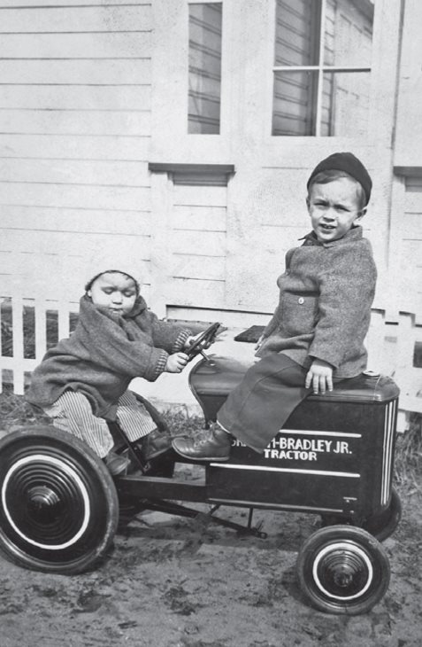 My brother Lyman driving and I sharing our first four-wheeled vehicle in - photo 3