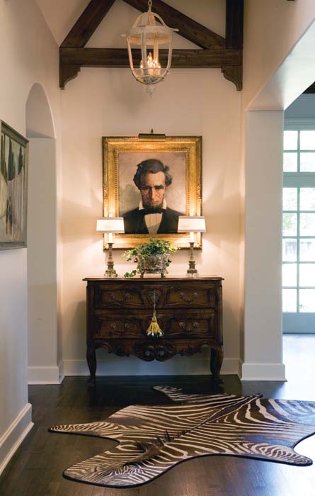 A painted entry lantern and a pair of lamps illuminate a soaring entry hall - photo 2