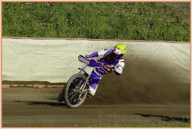 Dirt flies as a speedway racer power slides through the turn Flat track TT - photo 5