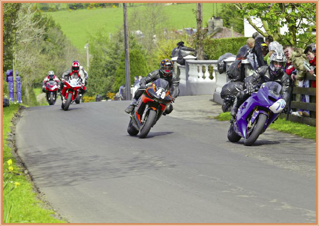 Racers make their way through a country neighborhood Spectators watch road - photo 9