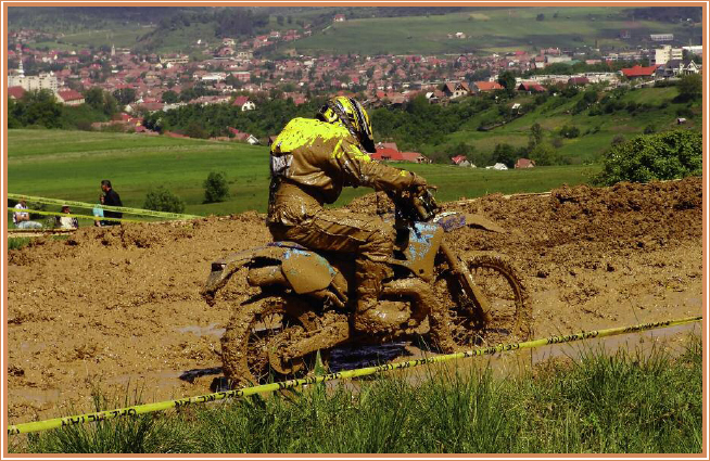 A mud pit challenges the rider and his machine A crowd gathers to watch a - photo 6