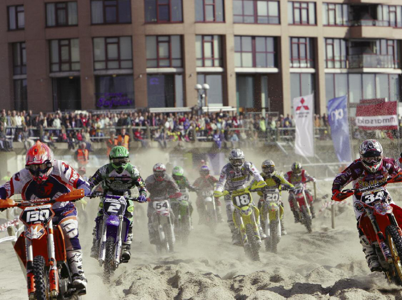 A crowd gathers to watch a motocross race Motorcycle racetracks can be as - photo 7