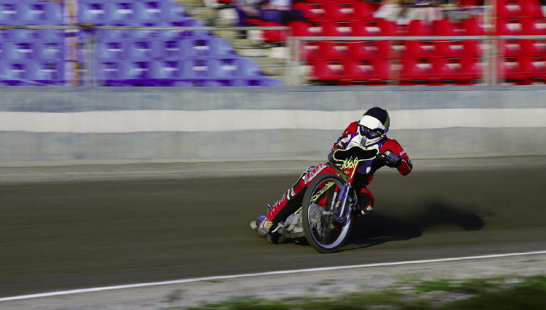 A speedway racer power slides his way around a turn A sidecar team leans - photo 10