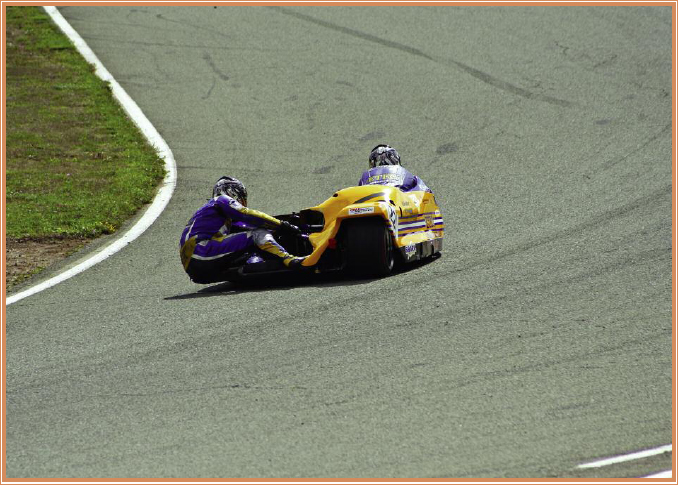 A sidecar team leans into a turn Sidecar racing is a team sport One racer - photo 11