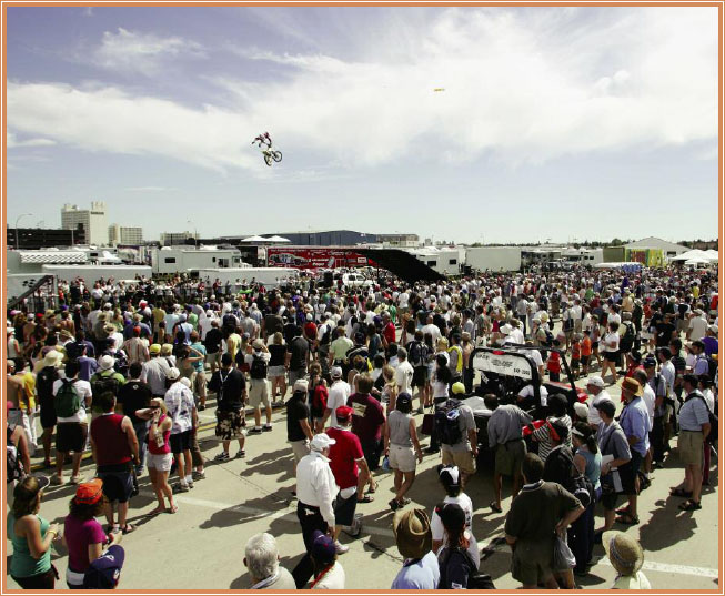 A large crowd watches as a trick rider gets huge air between ramps FREESTYLE - photo 8