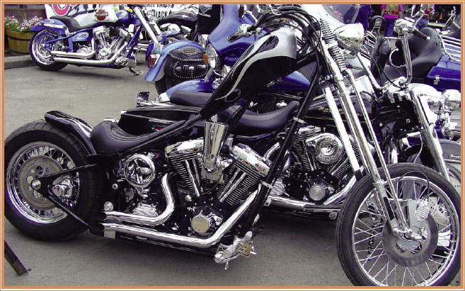 A traditional looking chopper with classic black leather seat black paint and - photo 6