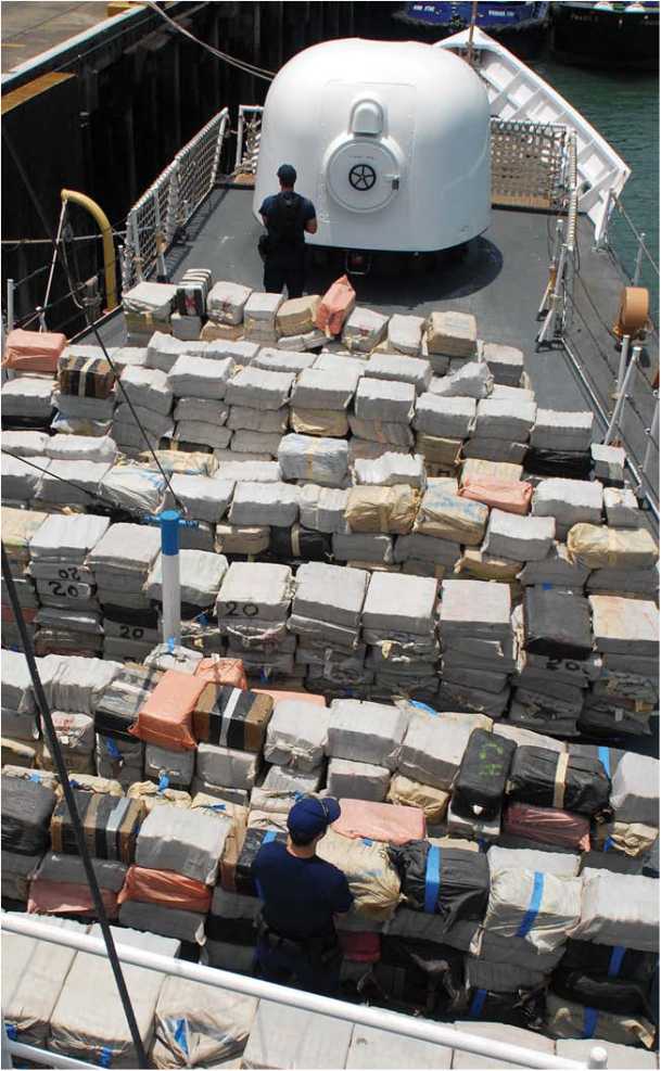 US Coast Guard officers guard 194 metric tons of cocaine confiscated from a - photo 6