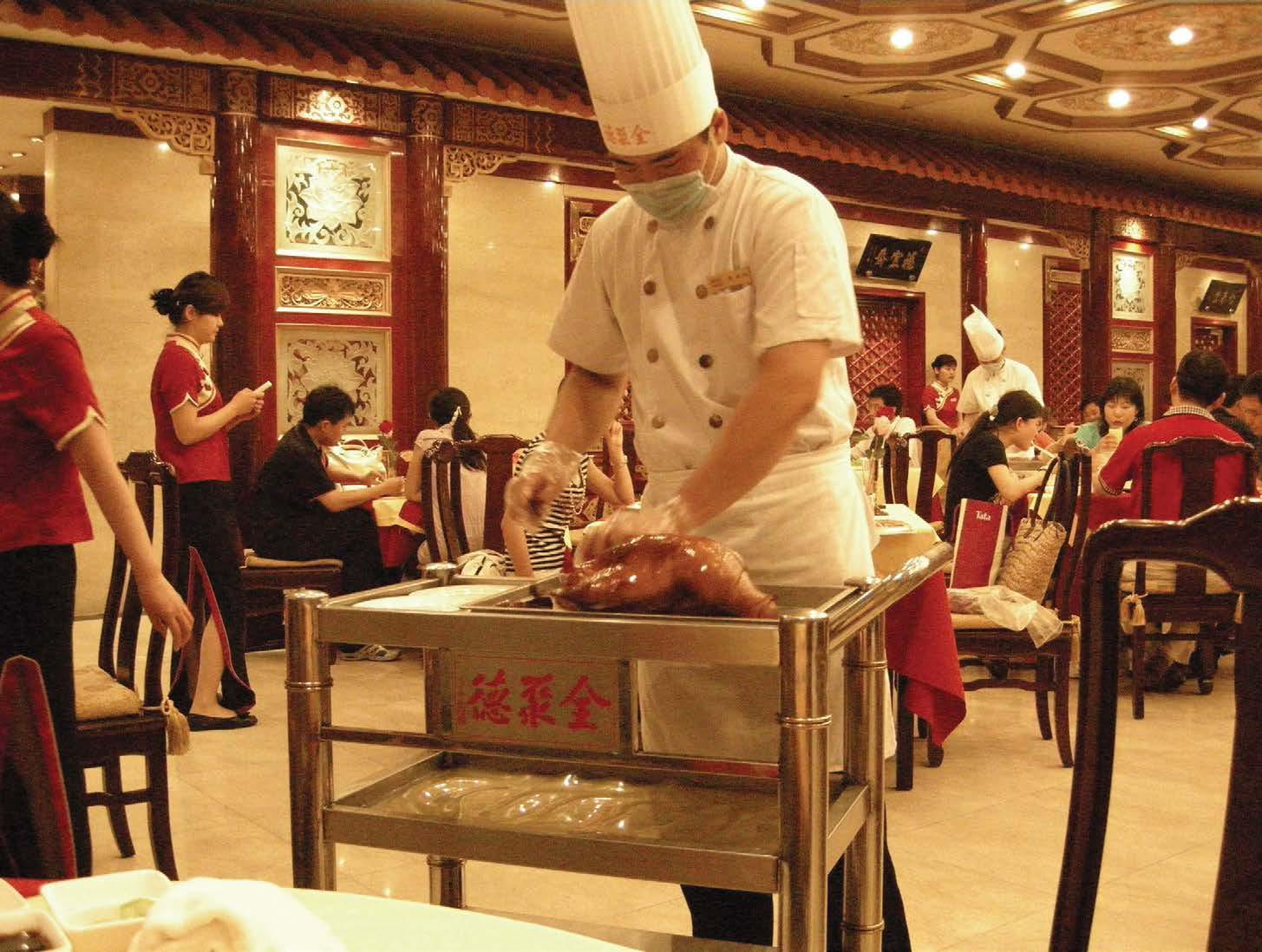 A chef carves Peking duck at the world-famous Beijing restaurant Quanjude - photo 6