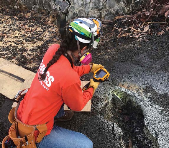 A geologist measures the temperature of a crack in the ground caused by a - photo 4