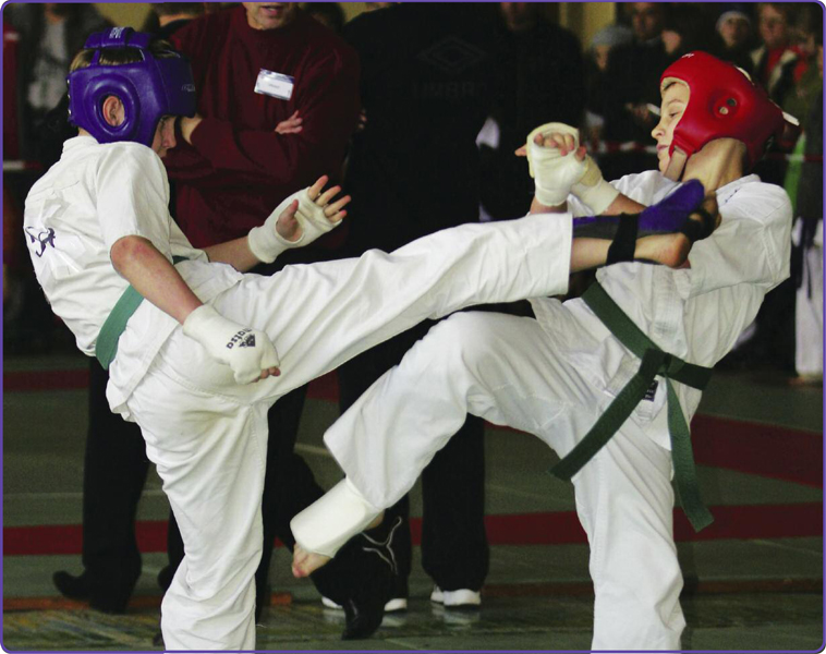 The kickboxer in the red helmet successfully blocks a kick from his opponent - photo 10