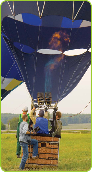 The envelope of a hot air balloon displays a variety of bright colors and - photo 10