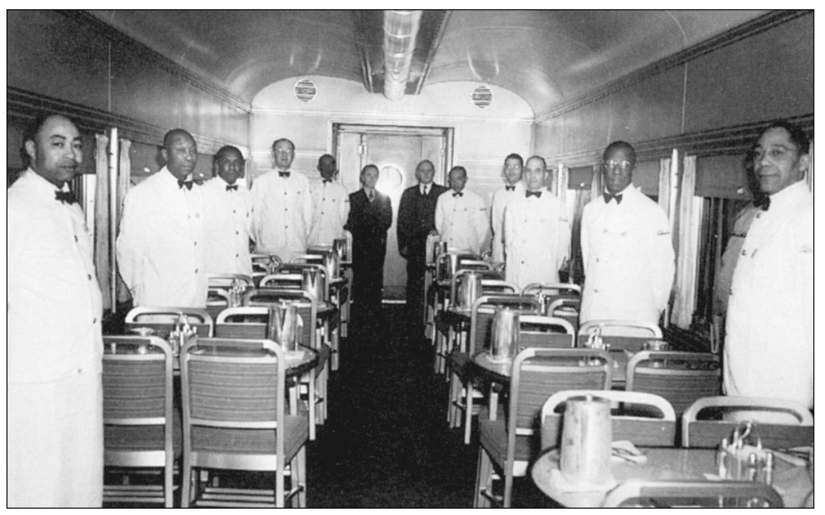 Here a group of porters stand at attention in the dining car before patrons - photo 7