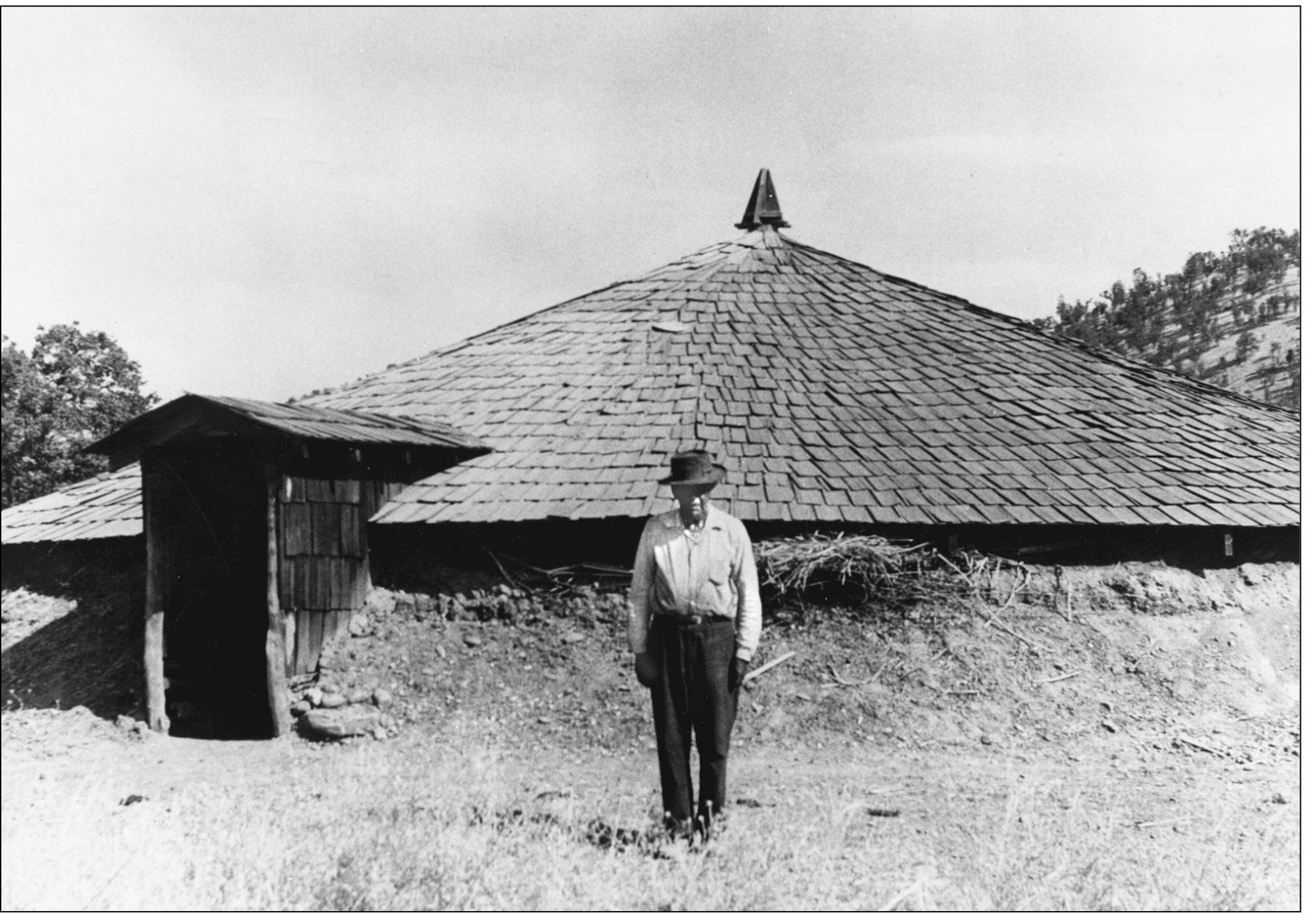 A Wintu Indian Wallace Burrows stands before the reconstructed roundhouse at - photo 4