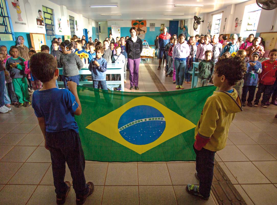 We sing the anthem of Brazil Students hold up the national flag After this - photo 9