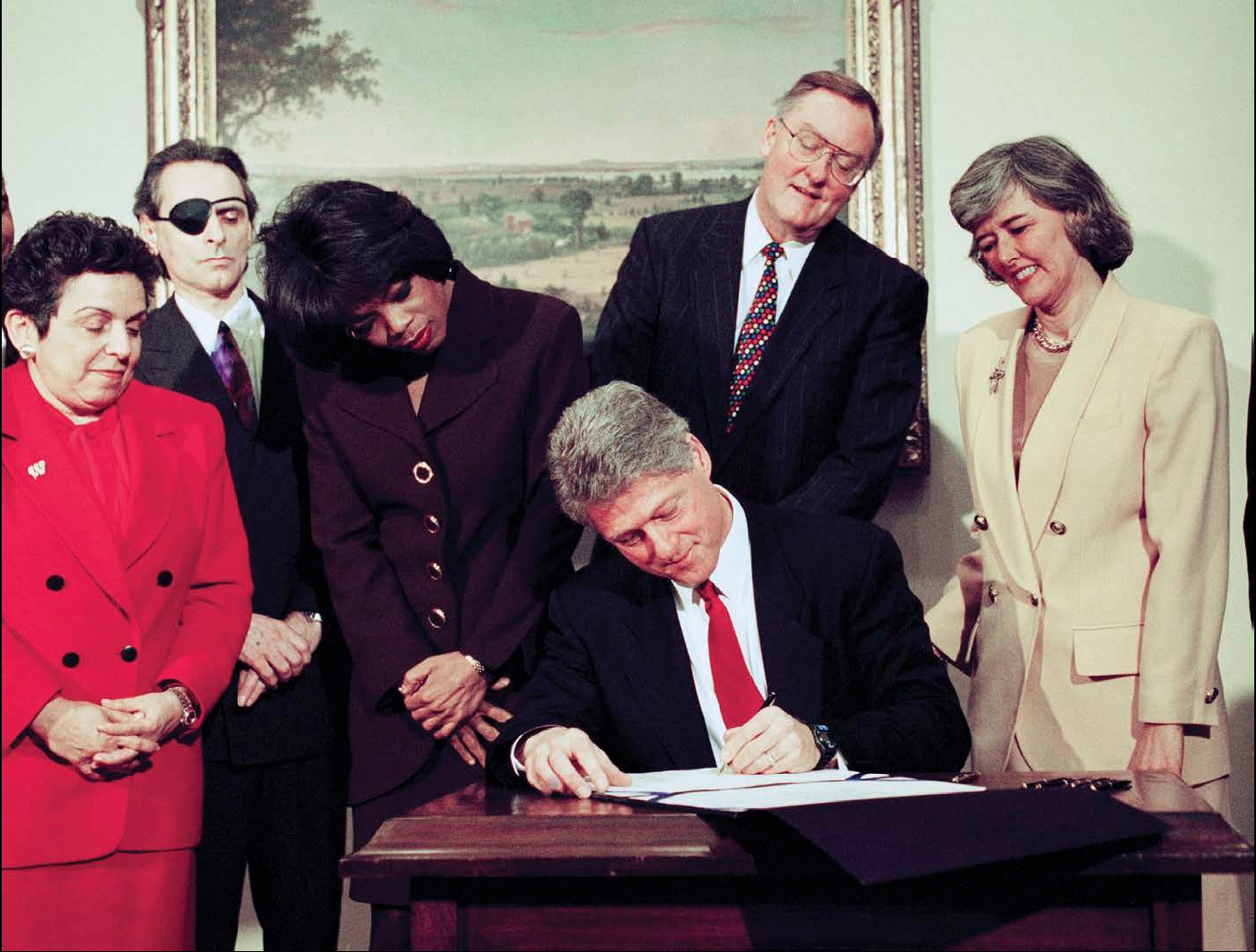 Oprah looks on as President Bill Clinton signs the National Child Protection - photo 8