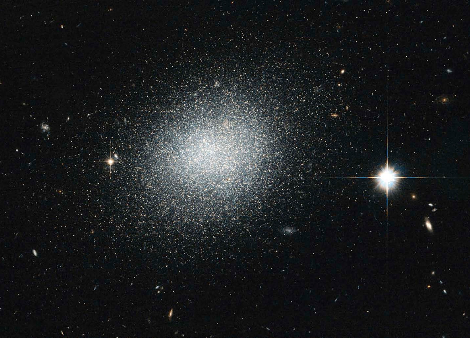This dwarf galaxy looks like grains of salt The galaxys blue color comes from - photo 3