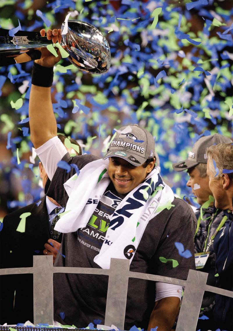 In the middle of a confetti storm Wilson raises the Lombardi Trophy high over - photo 4