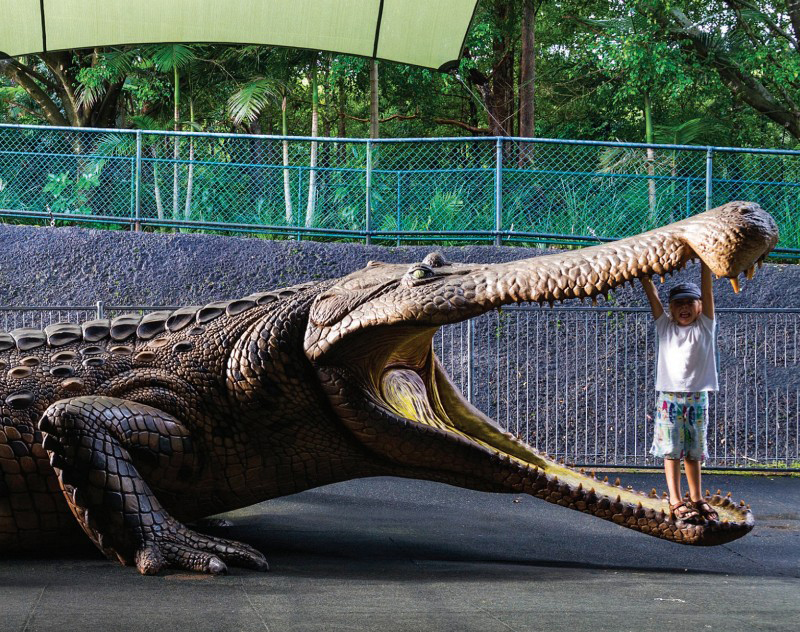 A YOUNG BOY STANDS INSIDE THE MOUTH OF THIS LIFE-SIZE MODEL OF SARCOSUCHUS - photo 4