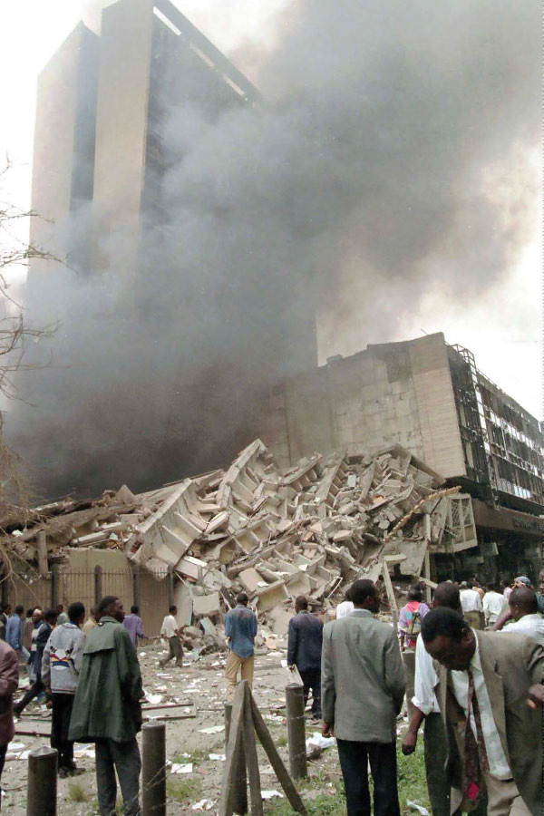 Shocked onlookers survey the damage to the US embassy in Nairobi Kenya on - photo 3