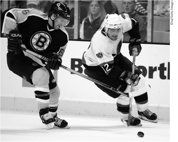 Fisher drives past Brad Stuart 6 of the Boston Bruins Ticking down the - photo 2