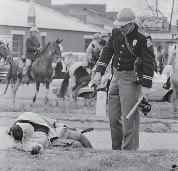 A state trooper stood over Amelia Boynton after she was attacked during the - photo 7