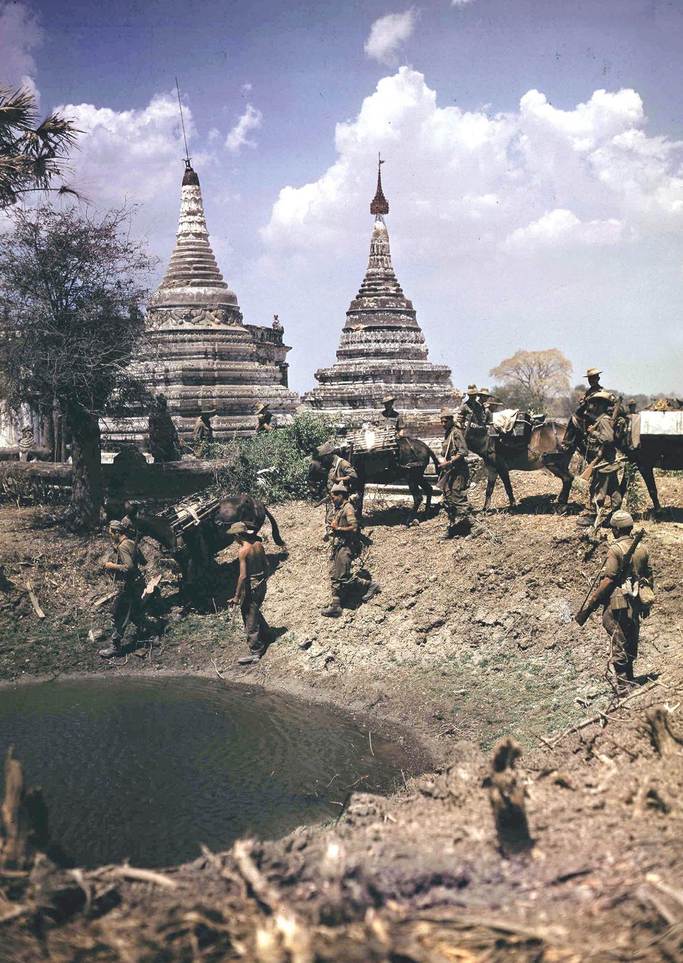 Indian soldiers and mules pass by a lake and a bullet-scarred Pagoda on the - photo 8
