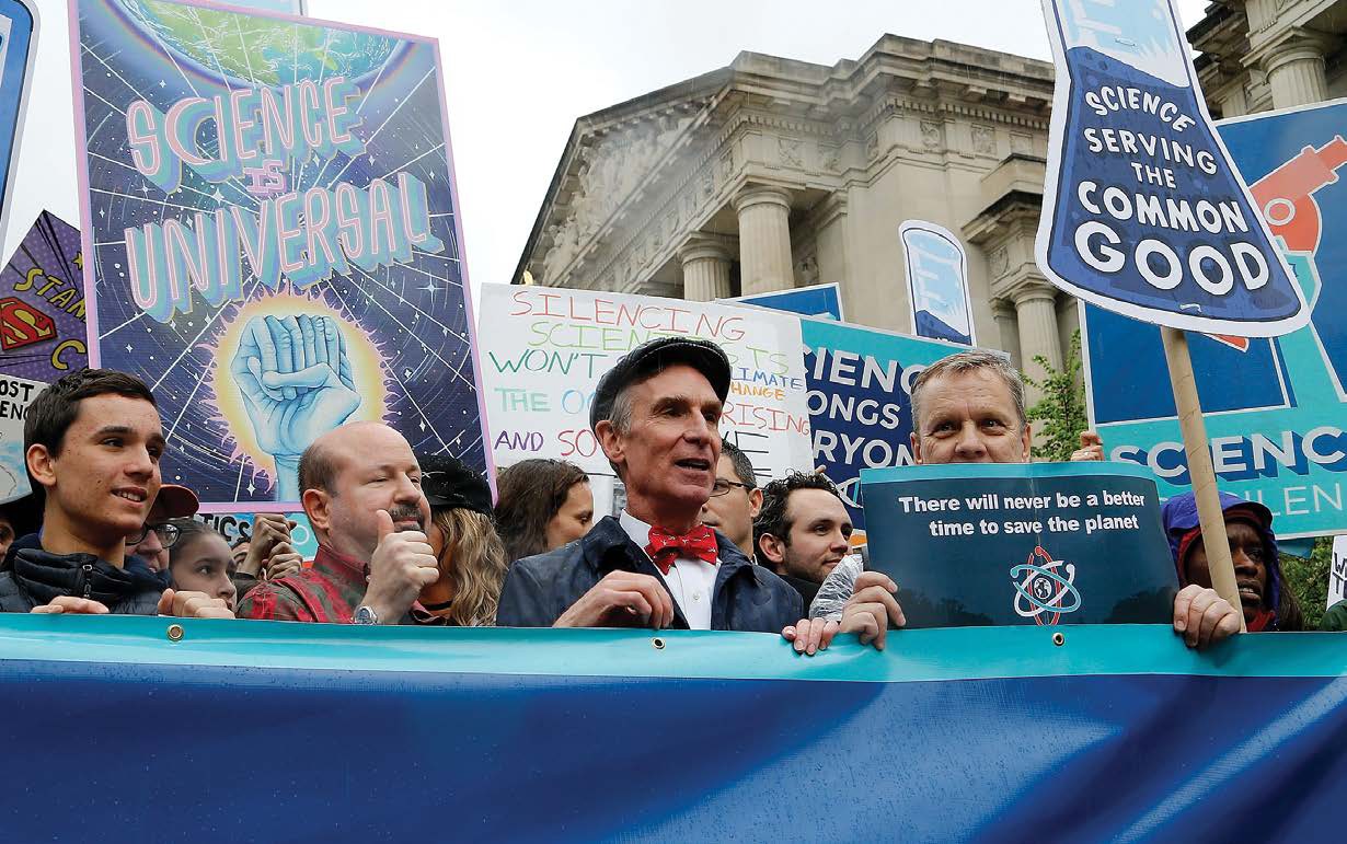 Bill Nye the Science Guy center walks with fellow protesters in the March for - photo 4