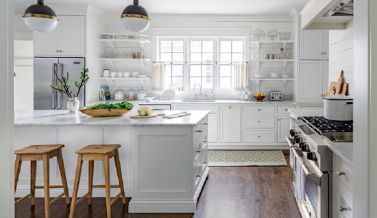 From the cabinetry to the paneling white envelops this farmhouse kitchen The - photo 11