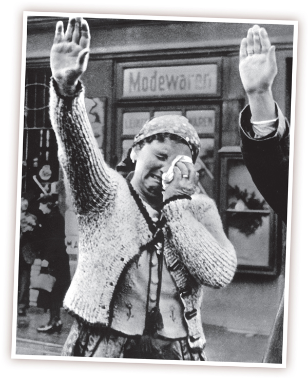 A woman couldnt hide her misery as she dutifully saluted the invading German - photo 3