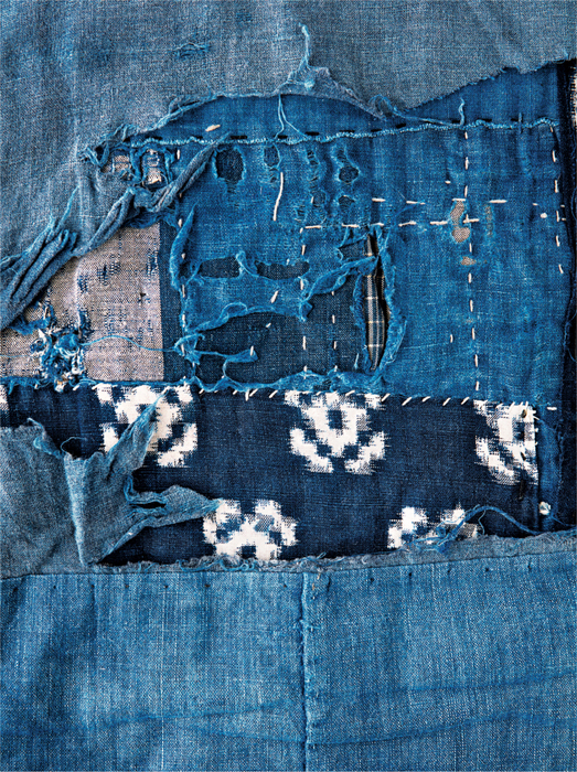 Detail from a Japanese patchwork quilt made from several layers of indigo-dyed - photo 6