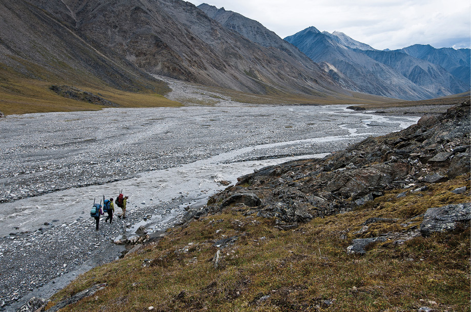 Hikers head downstream along Alaskas Jago River with their packrafts looking - photo 5