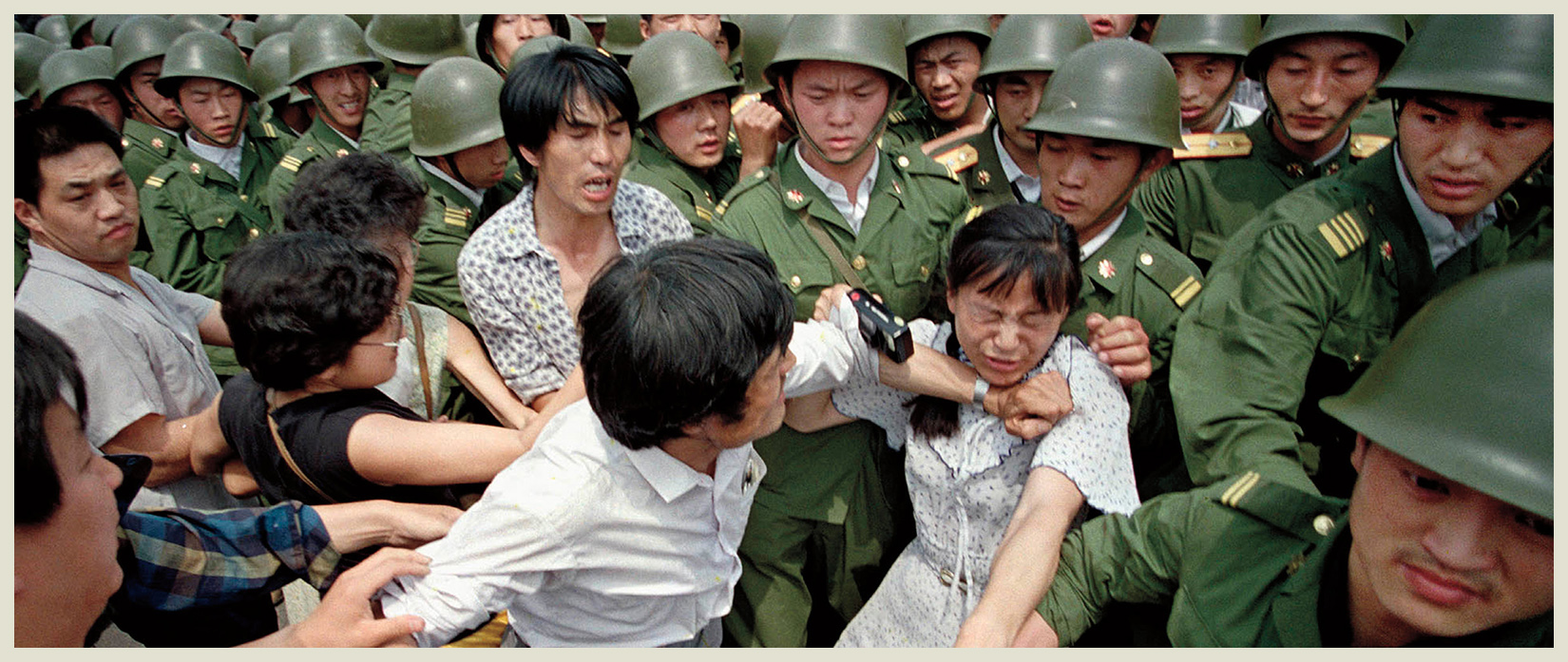 A young woman is caught between protesters and soldiers who were trying to - photo 5