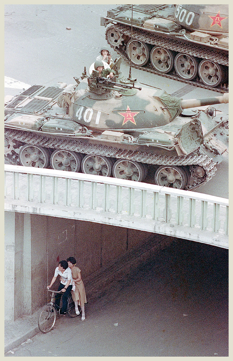 A couple takes cover at a Beijing underpass as tanks roll overhead on June 5 - photo 8