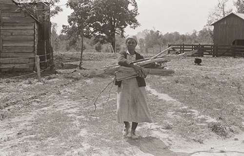 Aunt Nellie Pettway carrying wood for the fireplace from the yard 1939 Six - photo 9