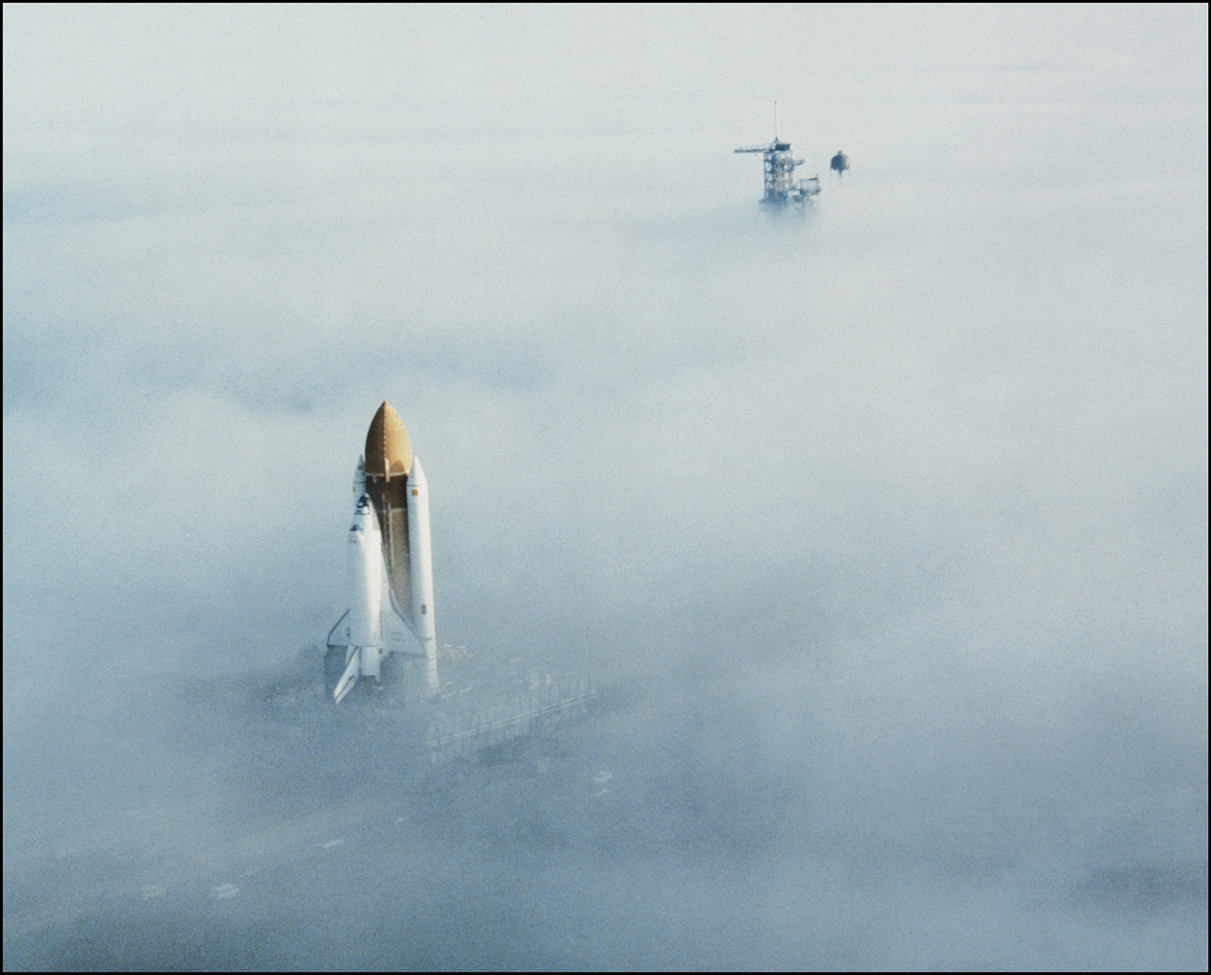 The space shuttle Challenger with its two white solid rocket boosters near the - photo 4