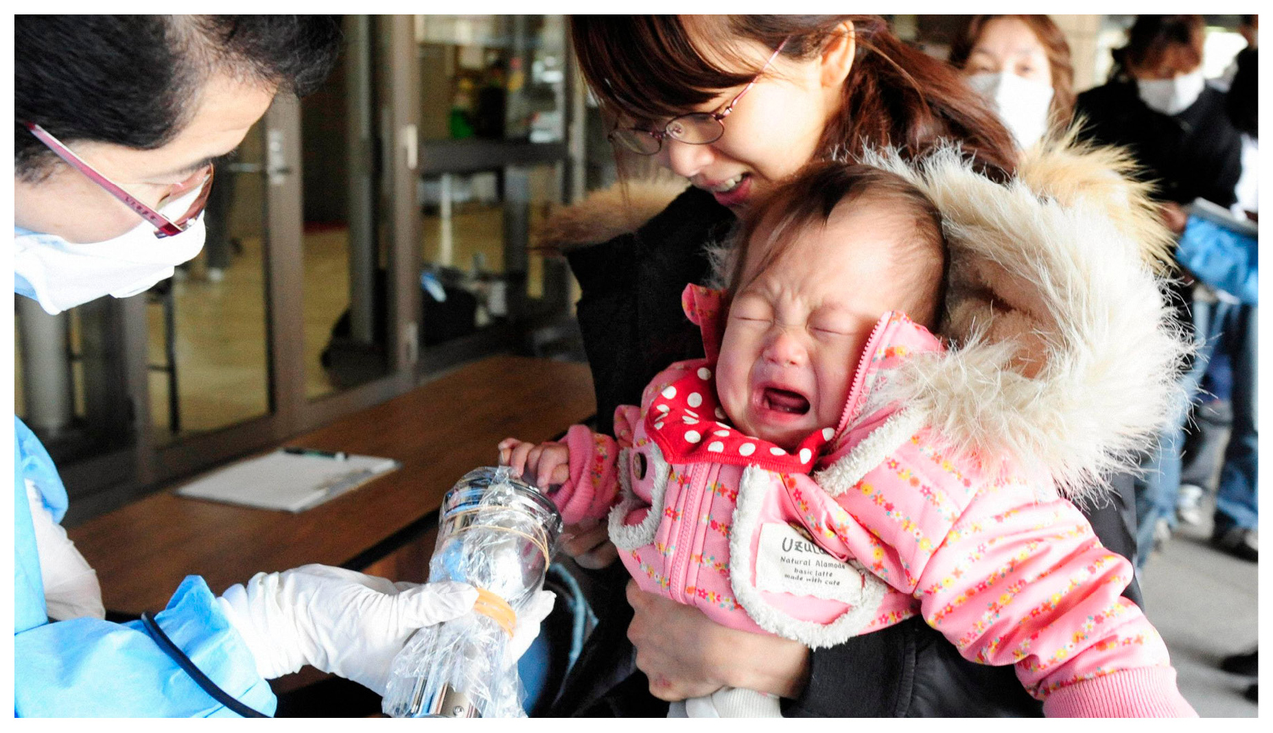 A baby and her mother were scanned for radiation at a Fukushima evacuation - photo 7