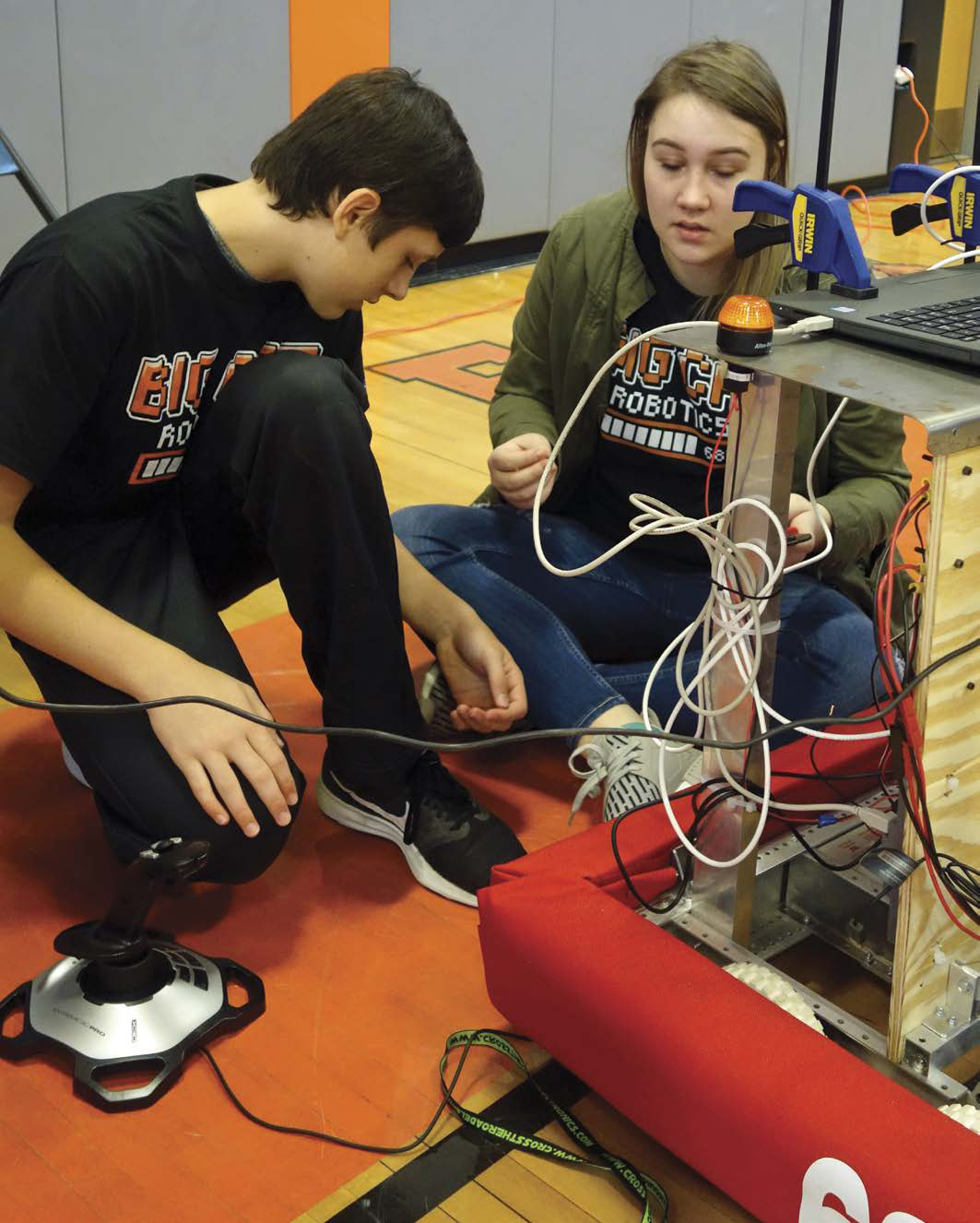 Members of a robotics team in Wellsville New York make adjustments to the - photo 4